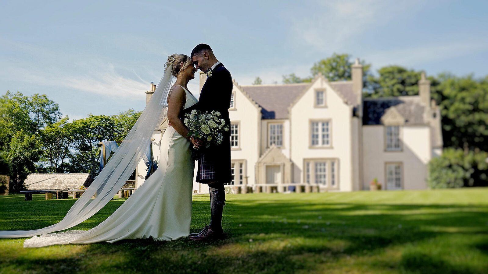 Romantic couple portrait outside Stemster House during a wedding in the Scottish Highlands.