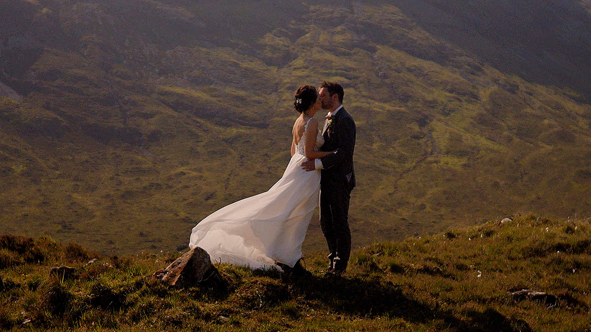 Close-up 50mm cinematic portrait of a wedding couple with the rugged Cuillin mountains as a backdrop on the Isle of Skye.