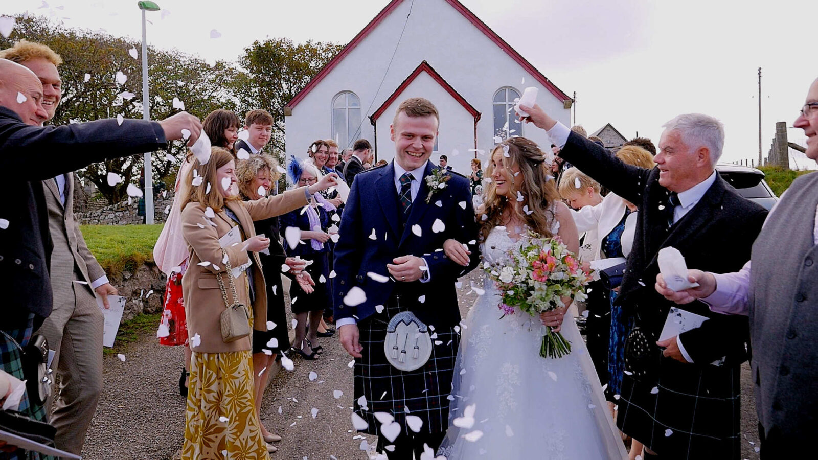 Joyful confetti moment for Kristina and Mark at Durness Church. A Greek-Scottish wedding fusion on the North Coast 500.