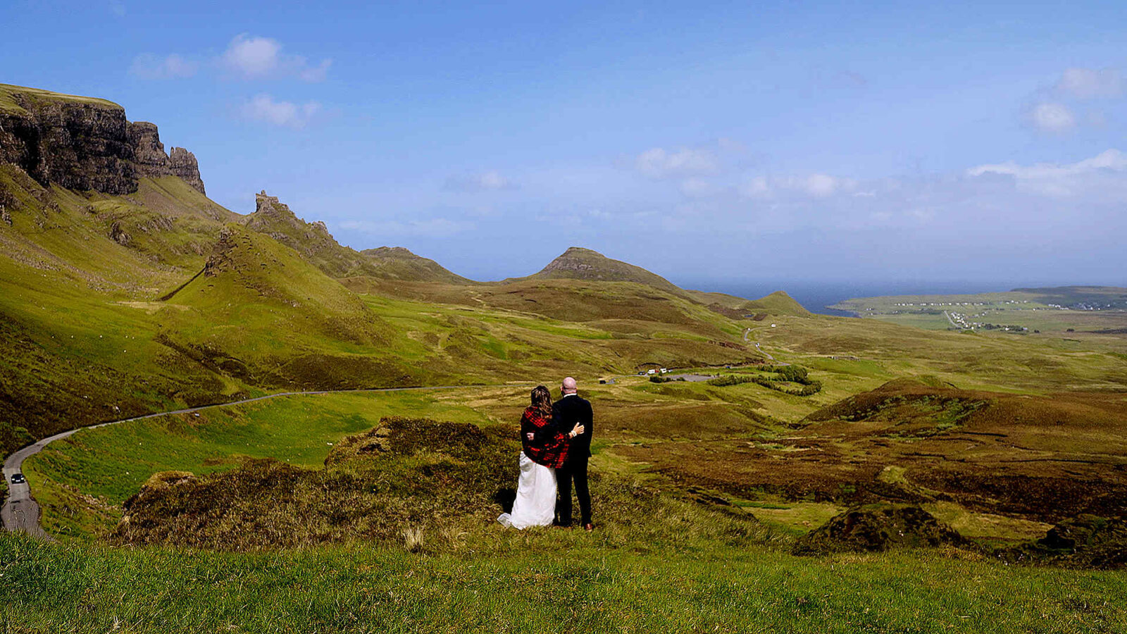 Epic aerial drone shot of an elopement couple among the iconic rock formations and ridges of the Quiraing, Isle of Skye.