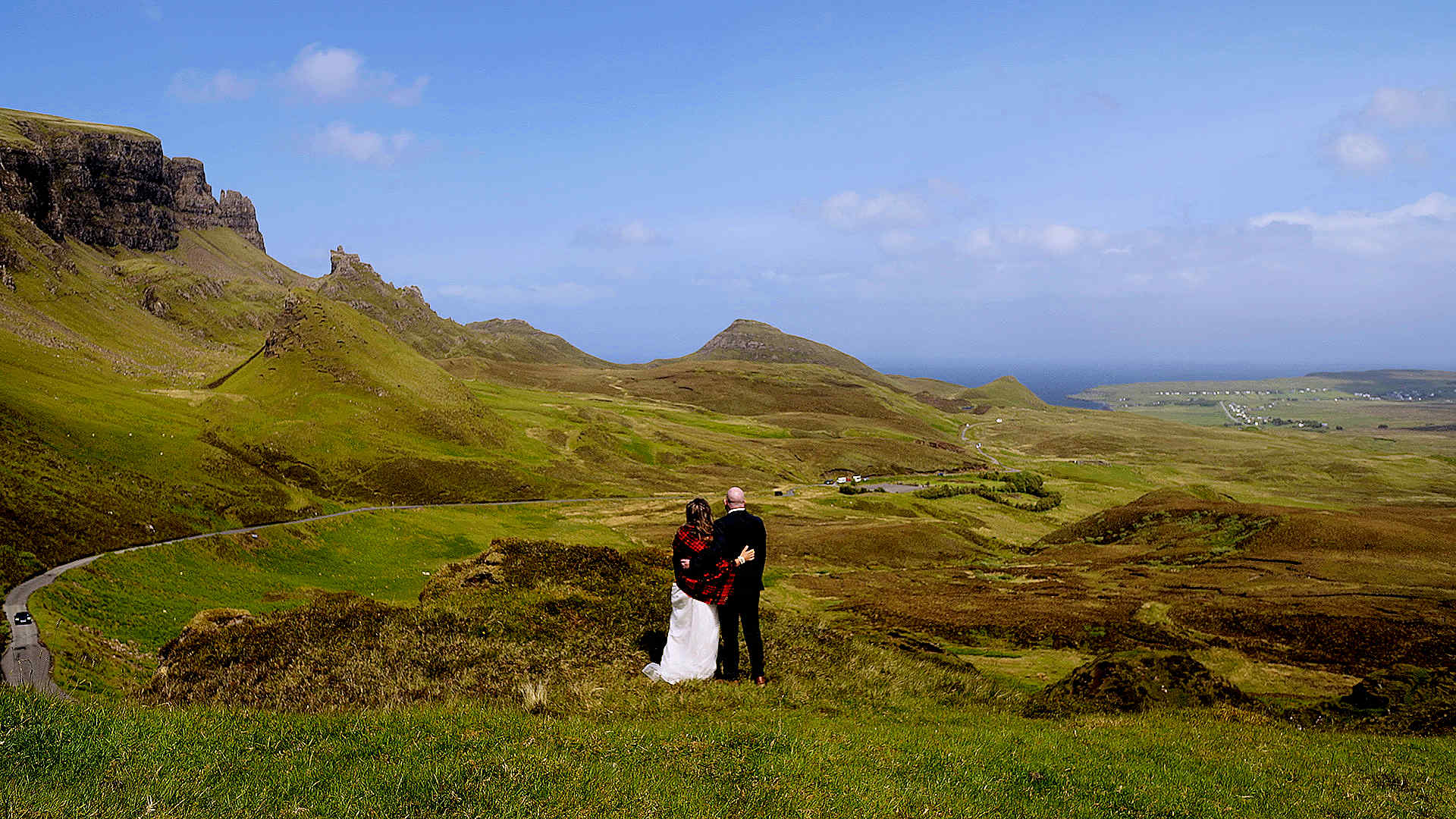Epic aerial drone shot of an elopement couple among the iconic rock formations and ridges of the Quiraing, Isle of Skye.